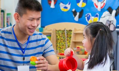 Father and daughter playing with plastic toys