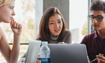 College students gathered around a computer screen