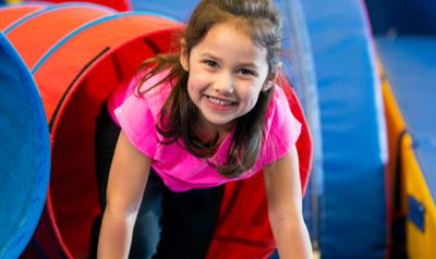 Girl climbing out of tube slide