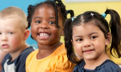 A diverse group of young children smiling