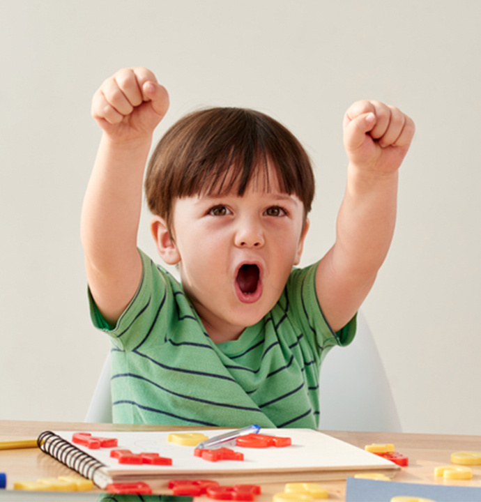 excited boy with arms up