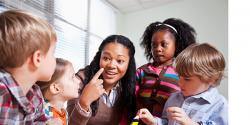 Preschool teacher in a classroom with a group of preschool children