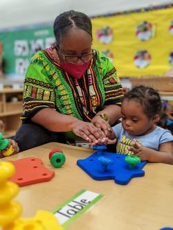 a teacher guiding a child through play