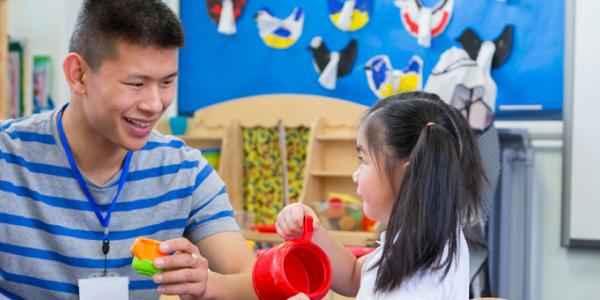 educator with young child