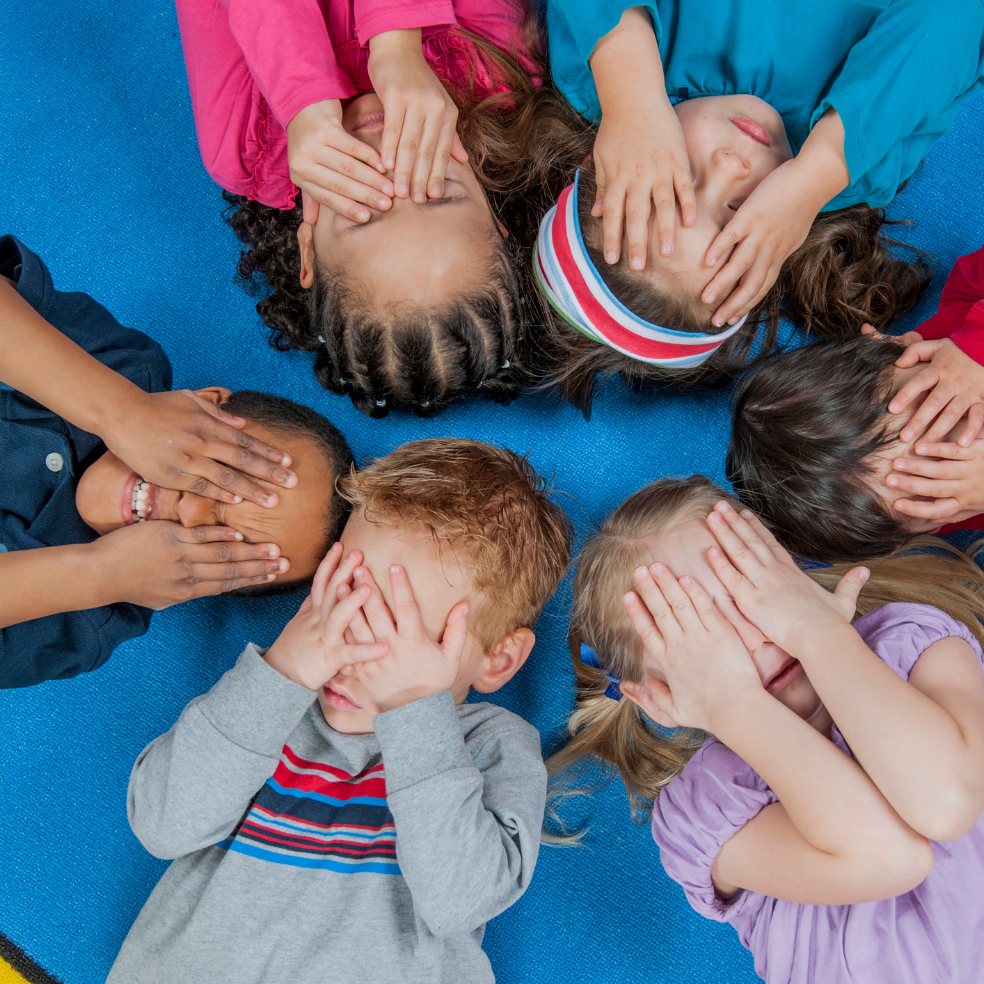 Children with hands over their eyes