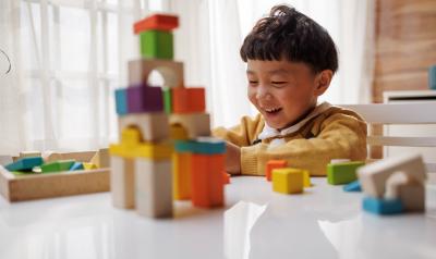 a child playing with blocks on a table