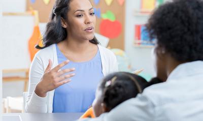 Teacher, parent, and child in a classroom