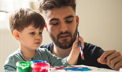 Man and preschooler painting.