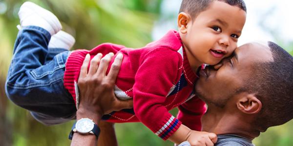 Dad embracing toddler