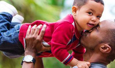 Dad embracing toddler