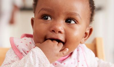 Toddler with hand in mouth