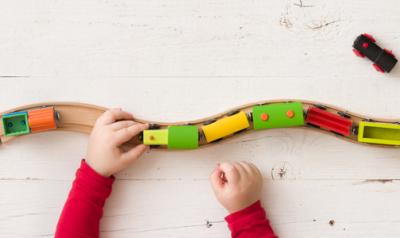 small hands playing with a train set