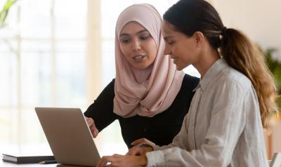 Two women looking at a laptop