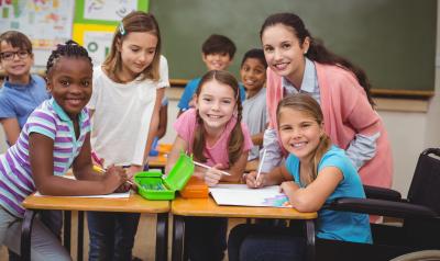 Teacher in a classroom with a group of early primary students