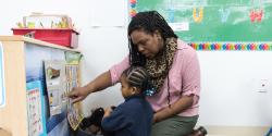 a teacher showing a child a picture