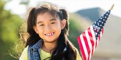 Preschool aged girl holding an American flag