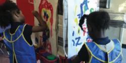 Two girls painting in classroom