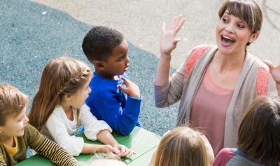 a teacher having fun with young students