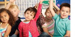 a group students raising their hands