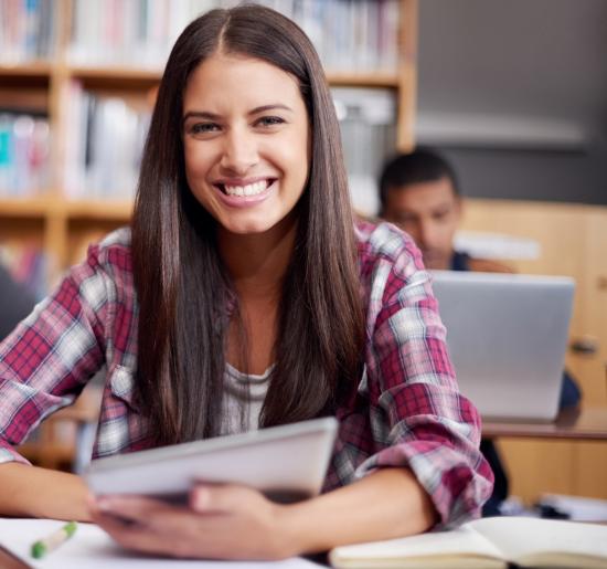 woman holding a notebook and smiling