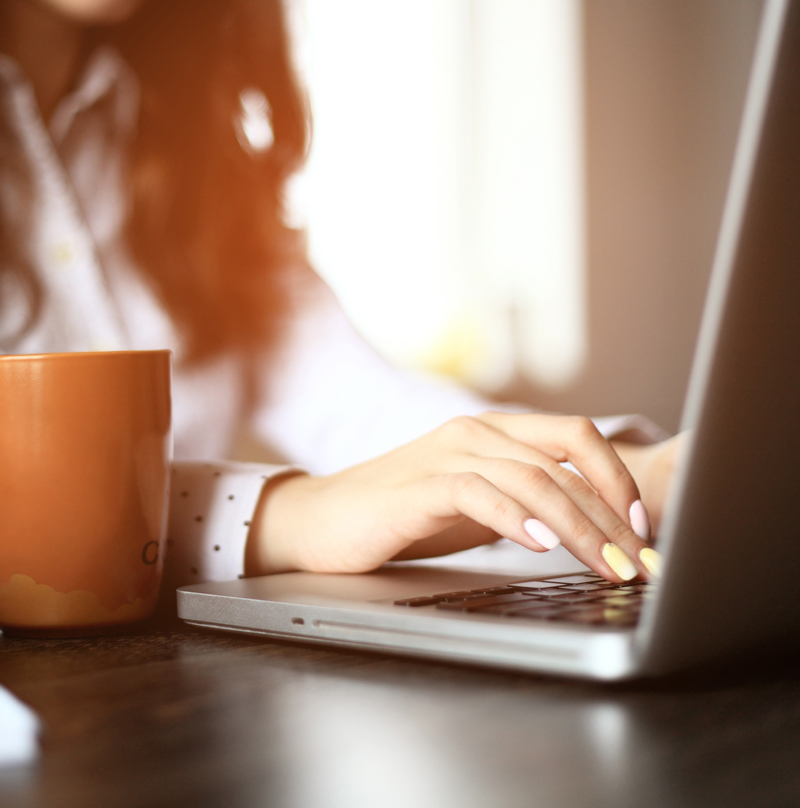 Woman typing on a keyboard