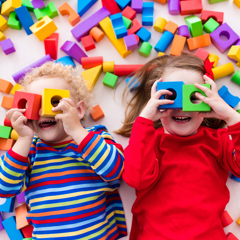 two children laying in blocks