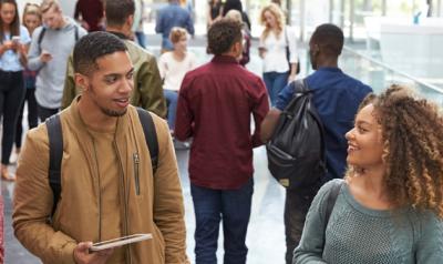 Group of young adults talking in a hallway