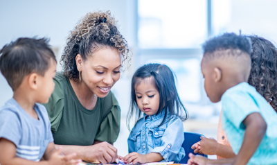 a teacher engaged in a project with young children