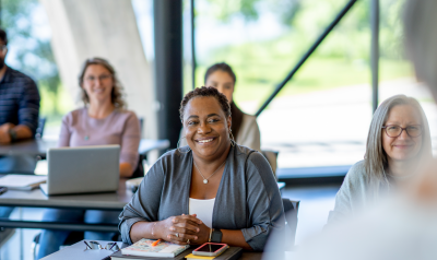 a group of professionals learning in a class setting