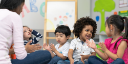 Children engage during circle time with a teacher.