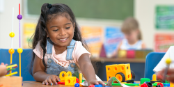 a child playing with toys on a table