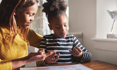 With support from her teacher, a young child develops math concepts.