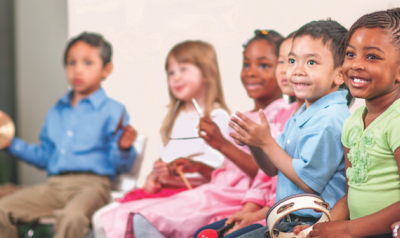 Children playing with musical instruments in class