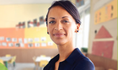 Teacher in a classroom smiling