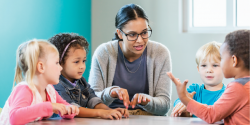 a teacher talking to a group of children